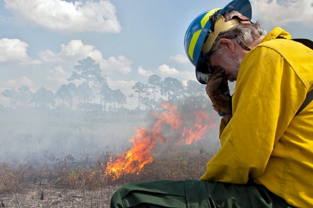 Smoke forces Dr. Bowman to nurse his stinging eyes.